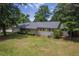Well-maintained single-Gathering home with lush landscaping, providing a serene and inviting atmosphere at 1350 Mosstree Rd, North Charleston, SC 29405