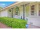 Inviting front porch featuring decorative ironwork, lush ferns, and a cozy seating area for relaxing outdoors at 1350 Mosstree Rd, North Charleston, SC 29405