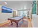 Bright game room featuring a pool table, hardwood floors, and a large television for entertainment at 1350 Mosstree Rd, North Charleston, SC 29405