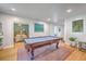 Spacious game room with a pool table, hardwood floors, and bright, neutral paint at 1350 Mosstree Rd, North Charleston, SC 29405