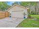 Detached garage with modern door and potted plants, enhancing the property's curb appeal and functionality at 1350 Mosstree Rd, North Charleston, SC 29405