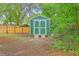 Practical green garden shed with double doors, ideal for storing tools and enhancing the outdoor space at 1350 Mosstree Rd, North Charleston, SC 29405
