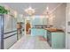 Charming kitchen with mint cabinets, stainless steel appliances, butcher block counters, and tile flooring at 1350 Mosstree Rd, North Charleston, SC 29405