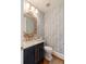 Powder bath featuring blue wallpaper, marble countertop and ornate gold framed mirror at 158 Mary Ellen Dr, Charleston, SC 29403