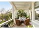 Inviting covered porch with charming seating, ceiling fan, and serene views creating an ideal outdoor retreat at 158 Mary Ellen Dr, Charleston, SC 29403