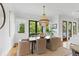 Bright dining area with modern chandelier, lots of windows, and outdoor views at 158 Mary Ellen Dr, Charleston, SC 29403