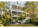 Multi-story home with outdoor living, featuring balconies, a lush yard, and patio perfect for relaxation and entertaining at 158 Mary Ellen Dr, Charleston, SC 29403