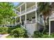 Two story beach house featuring porches with white columns and lush landscaping at 158 Mary Ellen Dr, Charleston, SC 29403