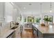 Bright kitchen features marble countertops, stainless appliances, and is open to the dining area at 158 Mary Ellen Dr, Charleston, SC 29403