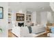 Bright living space boasts fireplace and a comfortable white sofa with views into the kitchen at 158 Mary Ellen Dr, Charleston, SC 29403