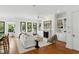 Living room with fireplace and built-in bookshelves, connecting to the kitchen and breakfast area at 158 Mary Ellen Dr, Charleston, SC 29403