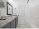 Bright bathroom featuring a shower-tub combo with white tile and a granite countertop vanity at 1738 Us-52, Moncks Corner, SC 29461