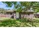 Backyard view shows a brick exterior with a white door and green grass at 202 Pamela Ln, Summerville, SC 29483