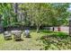 Spacious backyard with outdoor seating area, shed, and mature trees perfect for outdoor gatherings at 202 Pamela Ln, Summerville, SC 29483