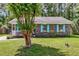 Charming single story brick home with a well manicured lawn and blue shutters at 202 Pamela Ln, Summerville, SC 29483