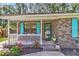 Inviting front porch with white railings, colorful shutters, and brick facade, perfect for enjoying the outdoors at 202 Pamela Ln, Summerville, SC 29483