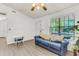 Bright living room with hard surface floors, large window, and comfortable blue couch at 202 Pamela Ln, Summerville, SC 29483