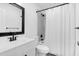 Bright bathroom with black fixtures, a vanity, and a shower-tub combination with white shower curtain at 202 Waterwood Dr, Goose Creek, SC 29445