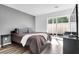 This bedroom features a gray accent wall, a large window with a sliding glass door, and a brown bed at 202 Waterwood Dr, Goose Creek, SC 29445