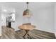 Open dining area with wood flooring, wicker pendant lighting, and adjoining kitchen at 202 Waterwood Dr, Goose Creek, SC 29445