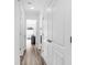 Hallway with wood floors, white trim, and multiple doors that lead to various rooms at 202 Waterwood Dr, Goose Creek, SC 29445