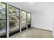 Cozy sunroom features many windows bringing in natural light and views of the surrounding greenery at 202 Waterwood Dr, Goose Creek, SC 29445