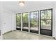 Comfortable sunroom with multiple windows, access to the outside, and a contemporary light fixture at 202 Waterwood Dr, Goose Creek, SC 29445