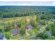 Expansive aerial view of a suburban home with a manicured lawn near a lush golf course and dense woodlands at 204 Bellerive Ln, Summerville, SC 29483