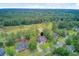Expansive aerial view of a suburban home with a manicured lawn near a lush golf course and dense woodlands at 204 Bellerive Ln, Summerville, SC 29483