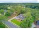 Aerial shot showcases a home surrounded by tall trees, lush landscaping, a manicured lawn, and neighborhood streets at 204 Bellerive Ln, Summerville, SC 29483