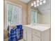 Bathroom features a vanity with a large mirror, white cabinets, and a window with natural light at 204 Bellerive Ln, Summerville, SC 29483