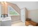 Bright attic bathroom with a triangular window, white vanity, and natural lighting at 204 Bellerive Ln, Summerville, SC 29483