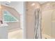 Tiled attic bathroom featuring a shower, a triangular window and a sink at 204 Bellerive Ln, Summerville, SC 29483