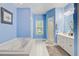 A blue bathroom has a shower, jacuzzi tub, and double sink vanity with white cabinets at 204 Bellerive Ln, Summerville, SC 29483