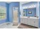 A blue bathroom has a double sink vanity and a tiled walk-in shower at 204 Bellerive Ln, Summerville, SC 29483