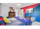 Bright bedroom with stylish blue and red accent walls, a ceiling fan and matching dark wood furniture at 204 Bellerive Ln, Summerville, SC 29483