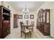 Formal dining room showcasing a glass-topped table and matching wooden hutch at 204 Bellerive Ln, Summerville, SC 29483