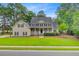 Beautiful two-story home with a classic design, a spacious lawn, and mature trees at 204 Bellerive Ln, Summerville, SC 29483