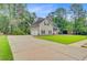 Spacious home featuring a two-car garage, large lawn, and mature trees at 204 Bellerive Ln, Summerville, SC 29483
