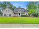 Charming two-story home featuring a welcoming front porch and a beautifully maintained lawn at 204 Bellerive Ln, Summerville, SC 29483