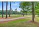 Golf course view with mature trees and well manicured lawn at 204 Bellerive Ln, Summerville, SC 29483