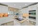 This kitchen is light and bright with an island cooktop, stainless double oven, and an eat-in breakfast nook at 204 Bellerive Ln, Summerville, SC 29483