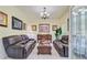 Cozy living room with plush brown sofas, elegant chandelier, and decorative artwork at 204 Bellerive Ln, Summerville, SC 29483