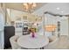 Open-concept area showcasing a breakfast nook, living room, and stairwell with a kitchen in the background at 204 Bellerive Ln, Summerville, SC 29483