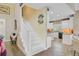 Inviting foyer with staircase leading to an open-concept kitchen featuring granite counters and white cabinets at 204 Bellerive Ln, Summerville, SC 29483