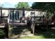 Exterior shot of back porch with patio furniture, steps, and shade from trees at 204 Pete Ewers Dr, Summerville, SC 29483