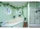 A bright bathroom featuring a soaking tub and a glass enclosed shower at 204 Pete Ewers Dr, Summerville, SC 29483