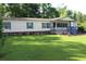 Charming single-story home with a welcoming porch and a spacious, well-maintained front yard at 204 Pete Ewers Dr, Summerville, SC 29483