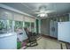 View of the sunroom with a rocking chair, cabinets, and natural lighting streaming through the window at 204 Pete Ewers Dr, Summerville, SC 29483