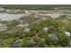 Aerial shot of neighborhood homes surrounded by lush vegetation and marshlands at 209 Jungle Rd, Edisto Beach, SC 29438